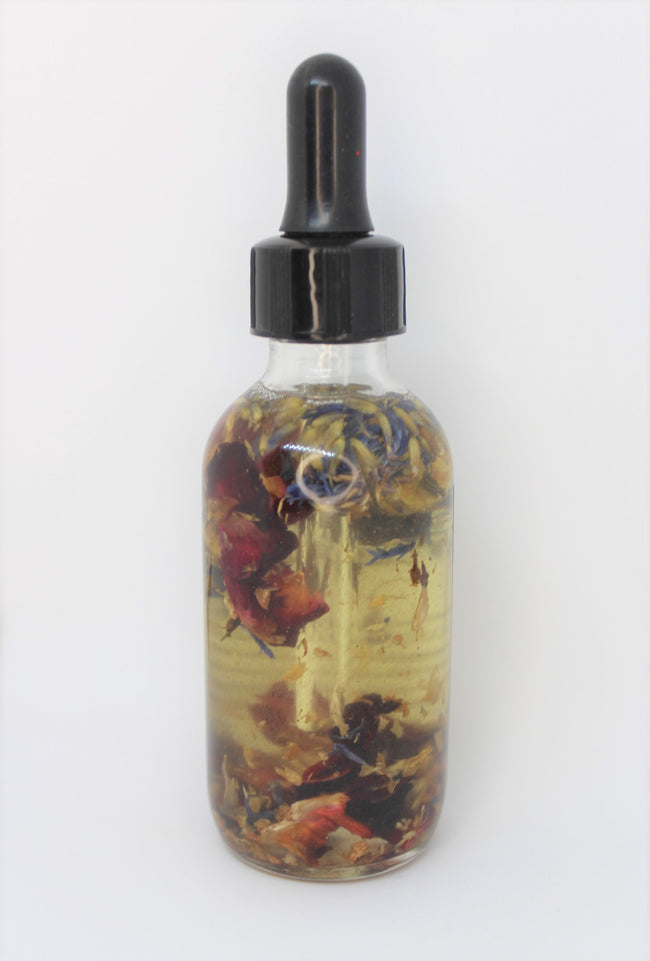 KSR Natural Kitty Potion in a 2 fl oz bottle. the beautiful herbs display themselves inside this concotion.